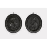 A pair of oval cast iron plaques with Sts. Peter and Paul