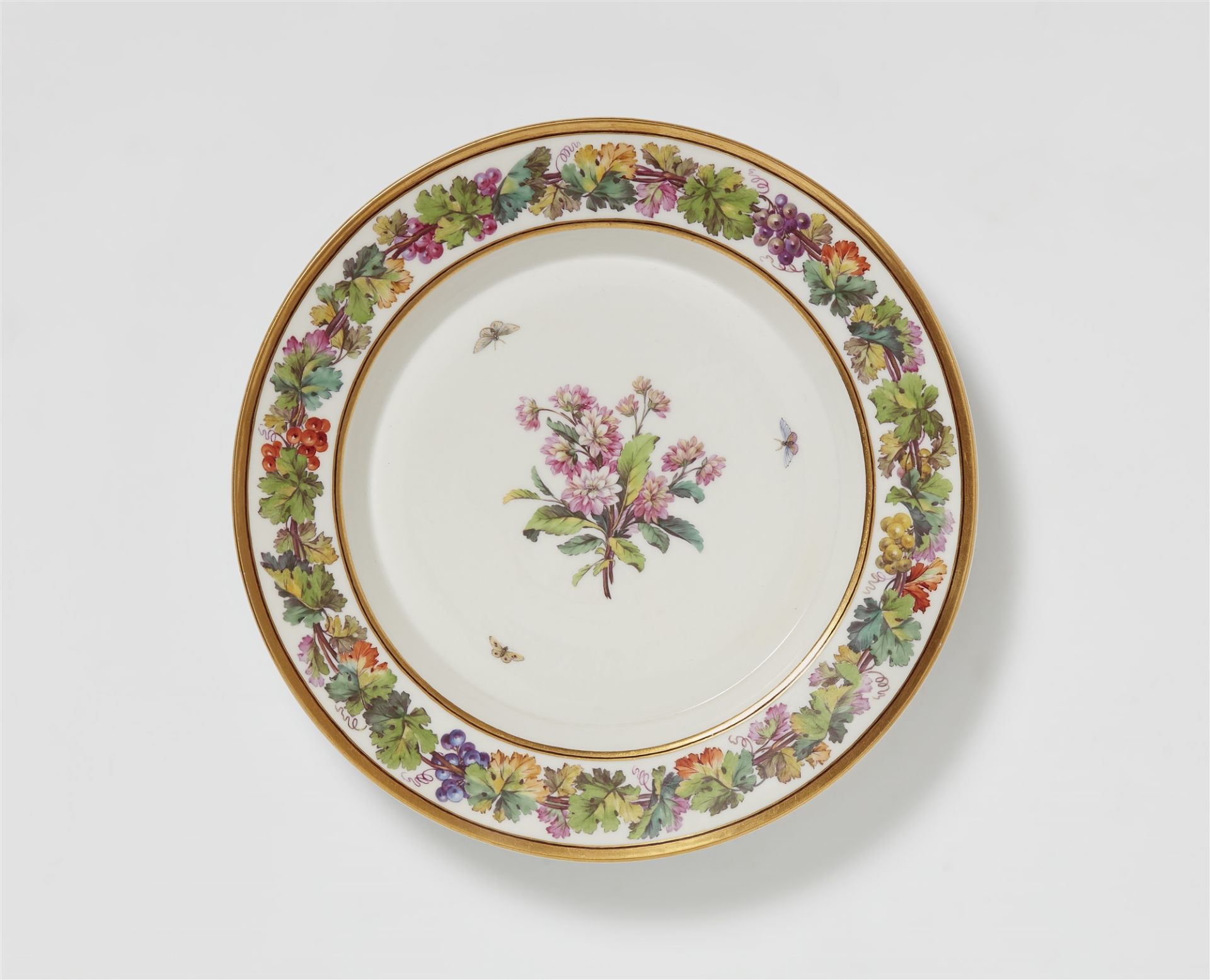 A Berlin KPM porcelain plate with chrysanthemums and moths