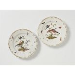 A pair of Berlin KPM porcelain plates from a dinner service with bird motifs