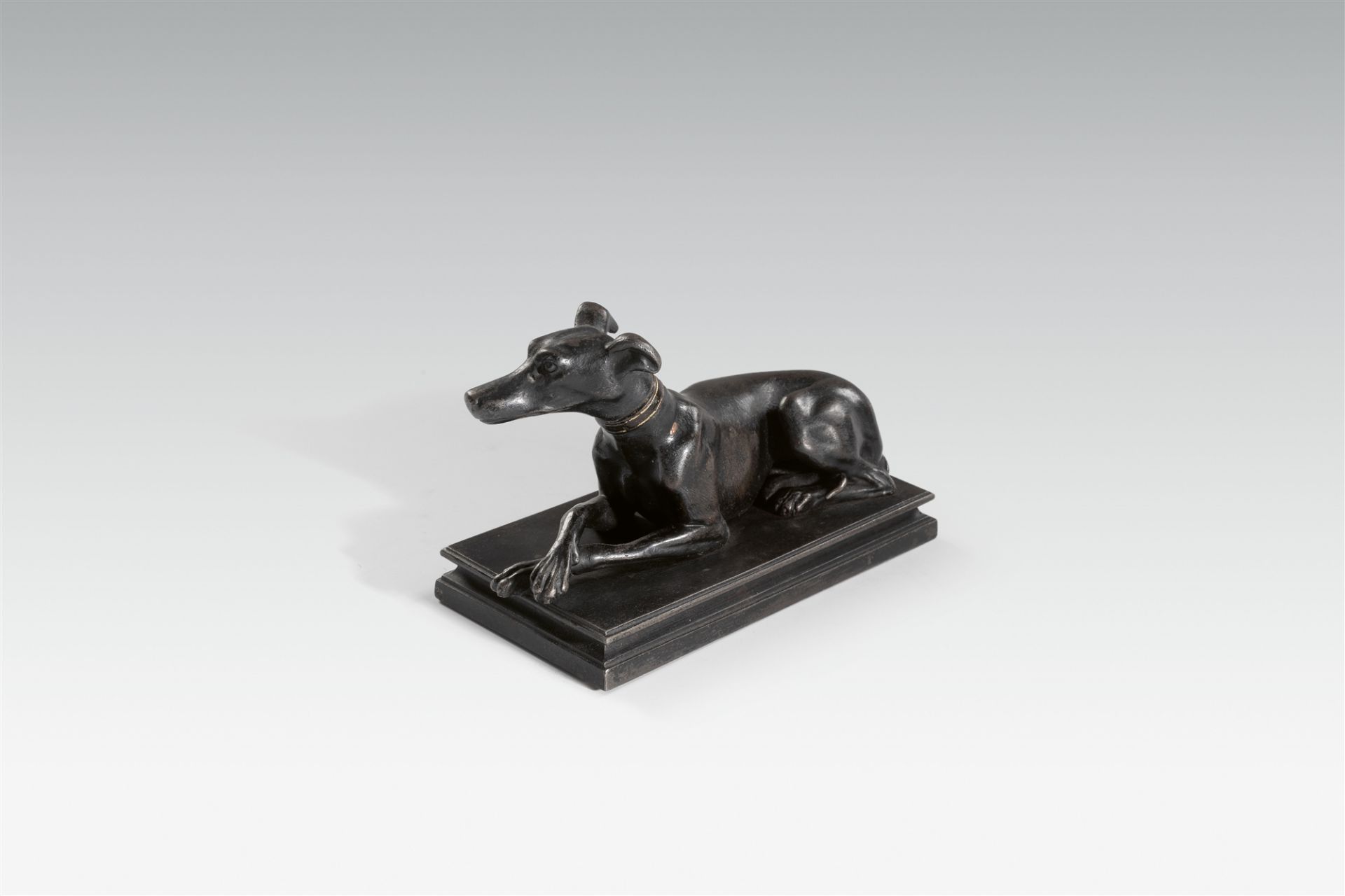 A cast iron greyhound paperweight