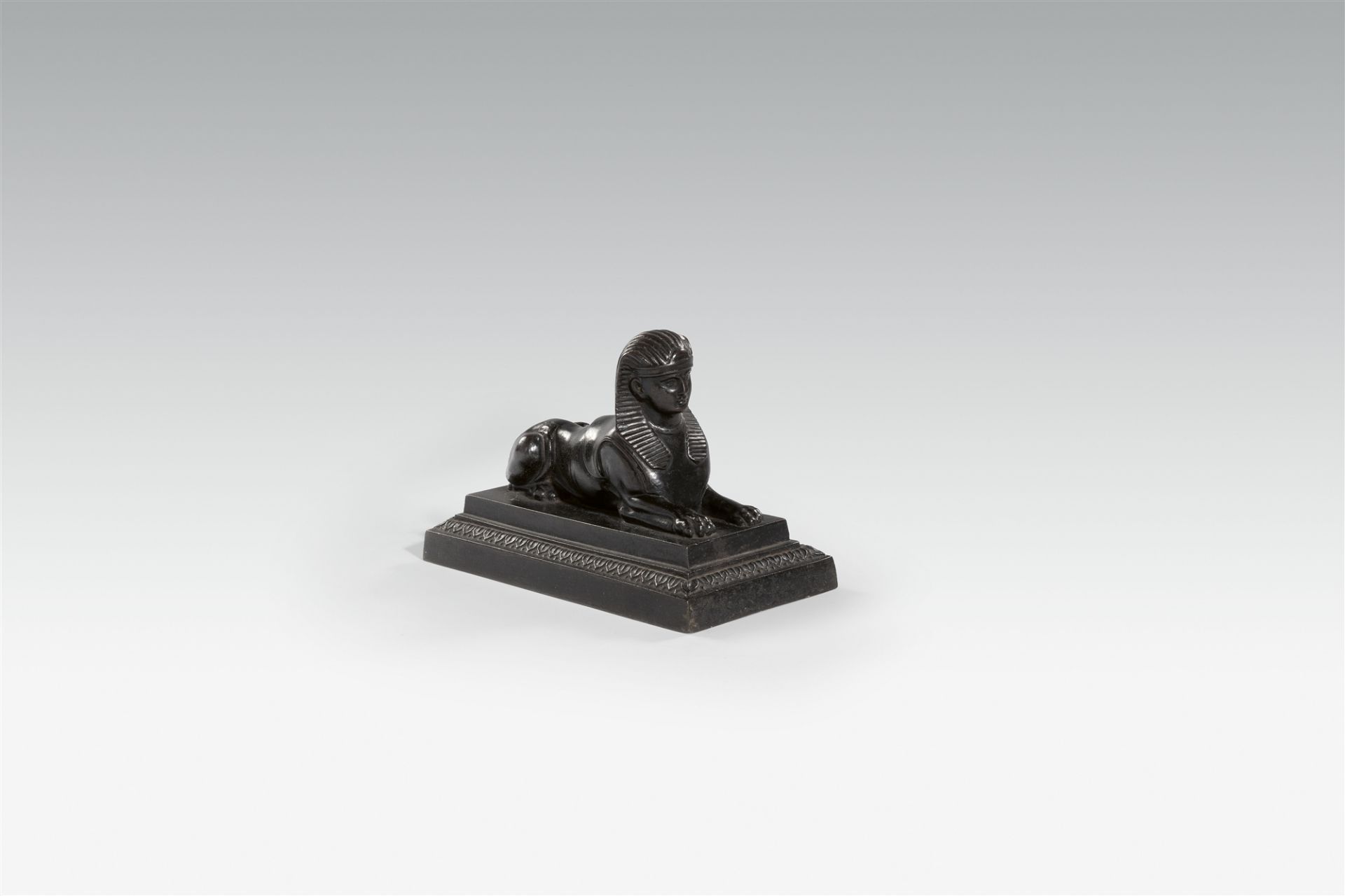A Prussian cast iron sphinx paperweight