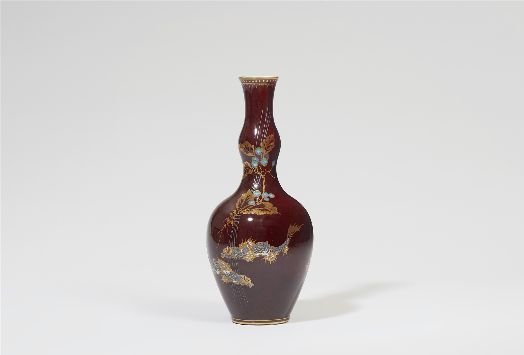 A Berlin KPM Seger porcelain gourd-form vase with sang de boeuf glaze and two Scorpaenidae fish in r