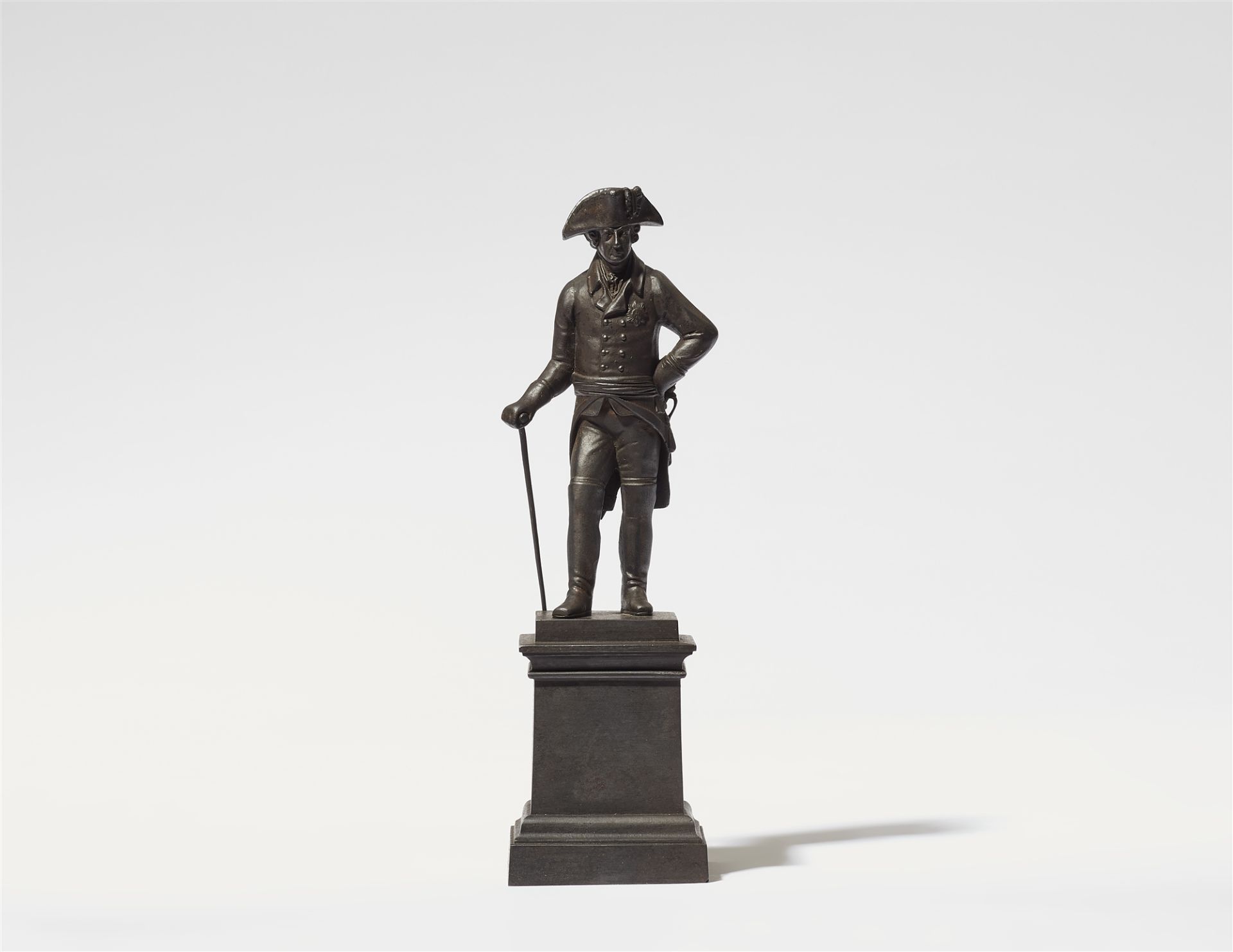 A cast iron statuette of King Friedrich II on a plinth