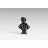 A cast iron bust of a gentleman with sideburns