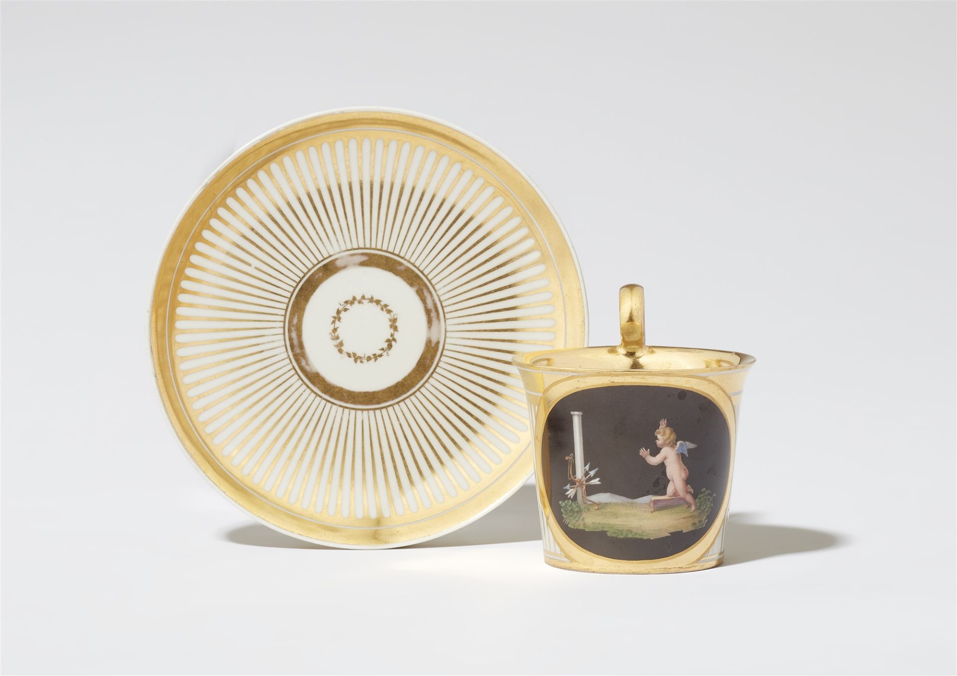 A Royal Vienna porcelain cup "Cupid rediscovers his weapons"