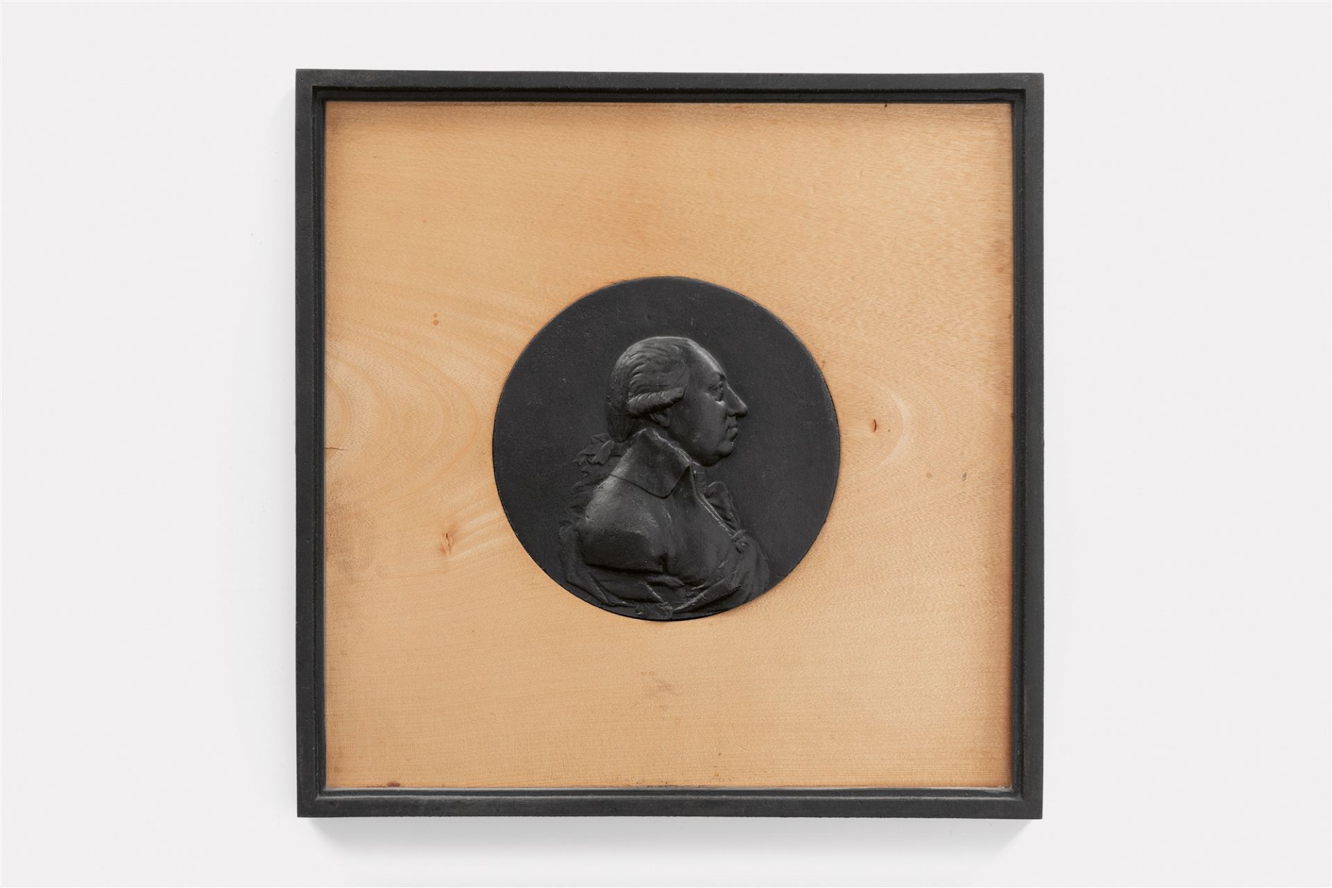 A round cast iron plaque with a portrait of King Friedrich Wilhelm II in profile