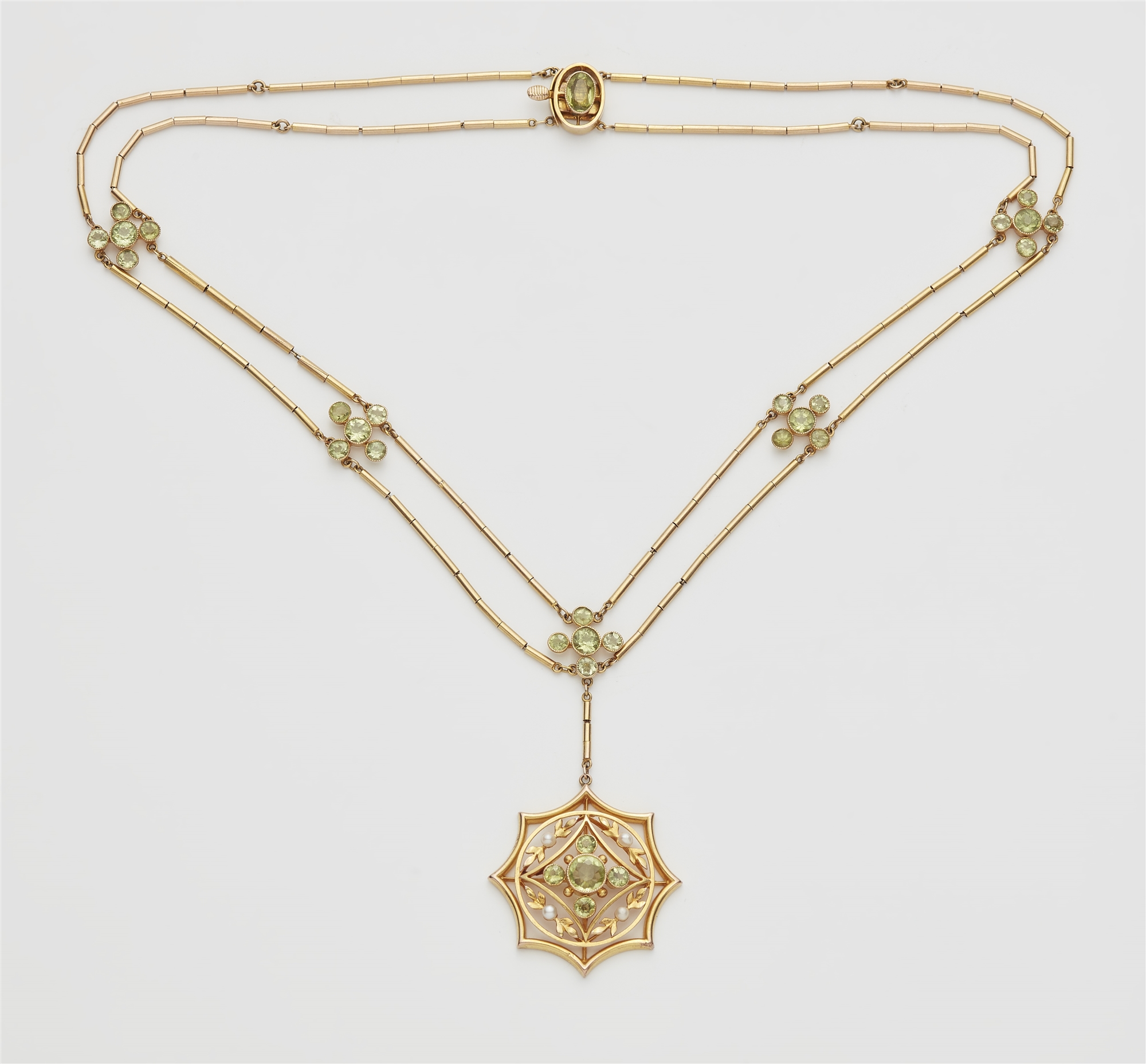 A probably English 9k gold and peridot pendant necklace.