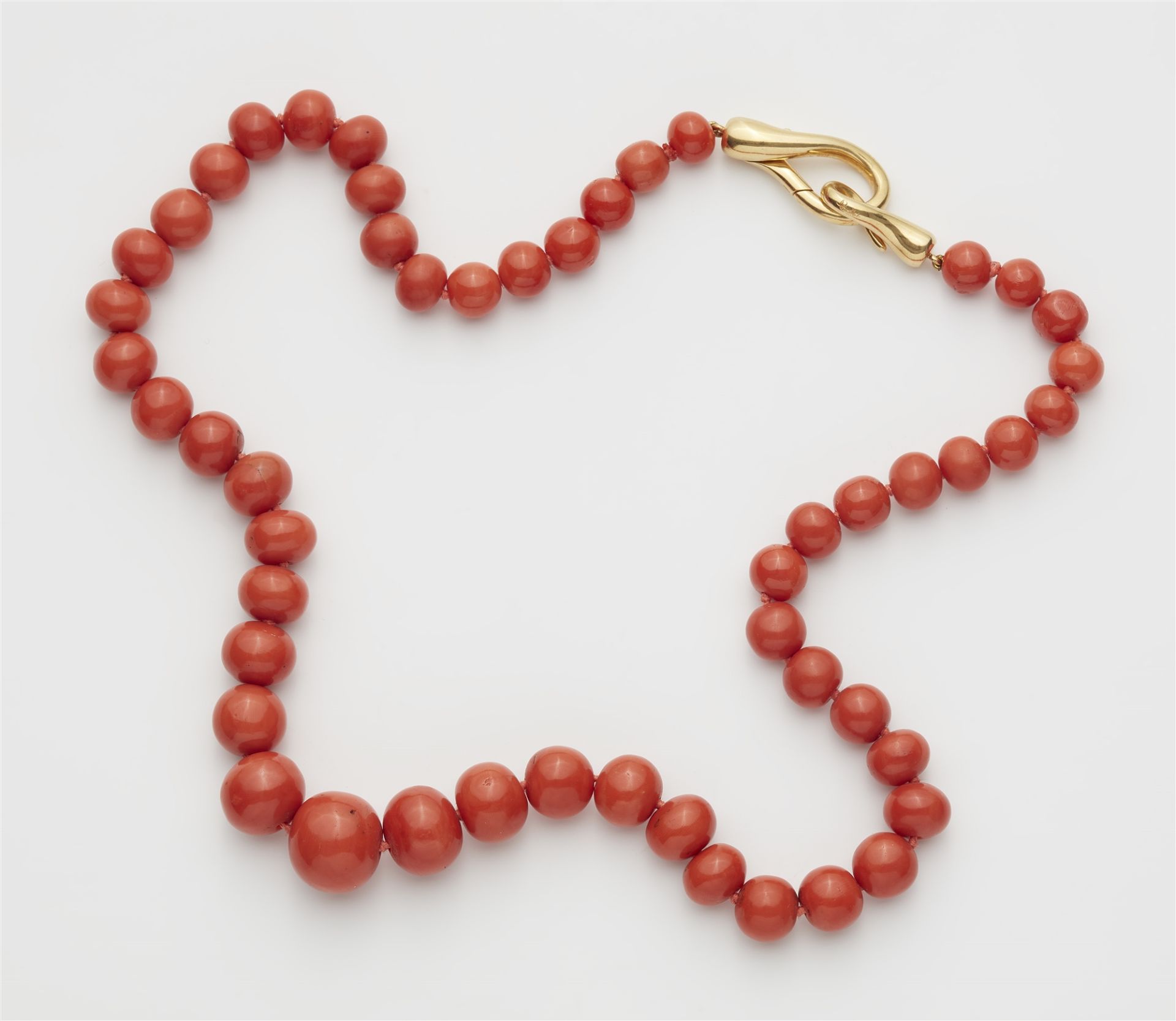 A coral necklace with an 18k gold Pomellato clasp.