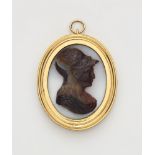 A copper gilt white and banded agate cameo pendant.