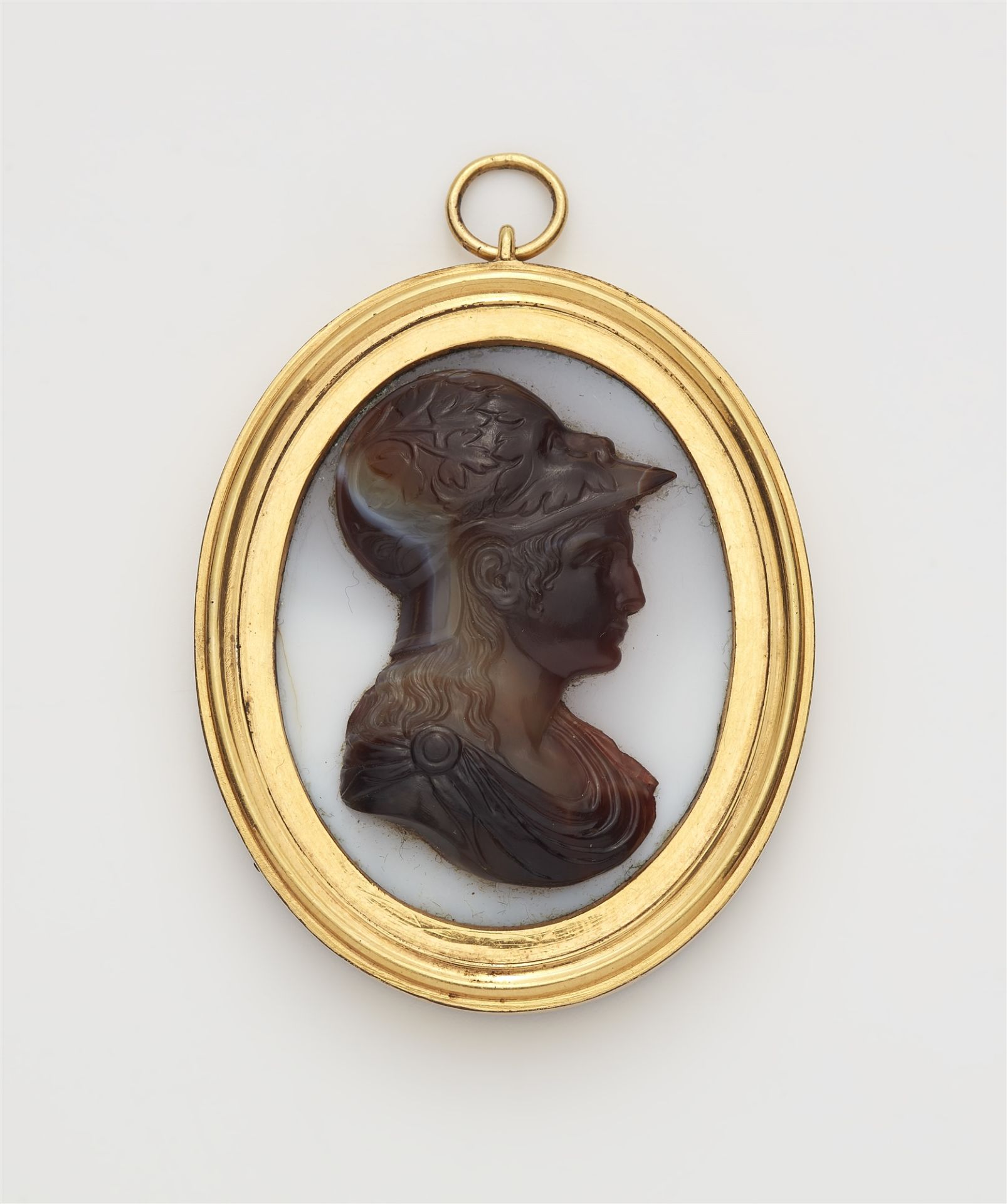 A copper gilt white and banded agate cameo pendant.