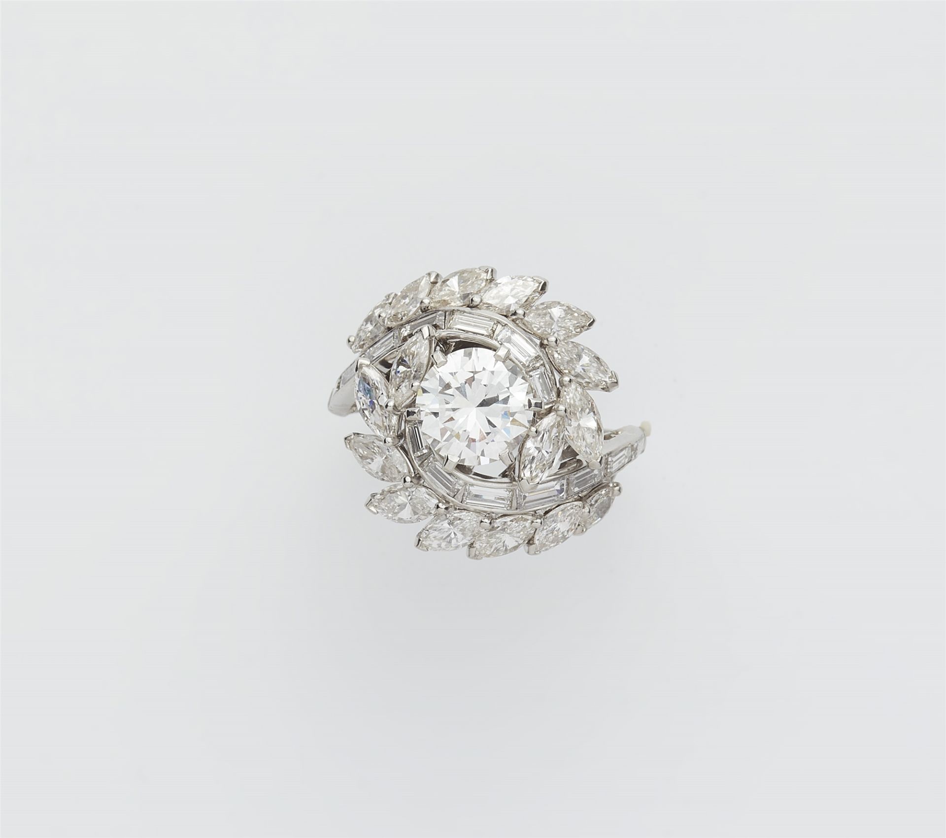 A platinum diamond swirl ring with a ca. 1.50 ct brilliant-cut diamond solitaire.