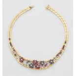 An 18k gold diamond sapphire and ruby necklace.