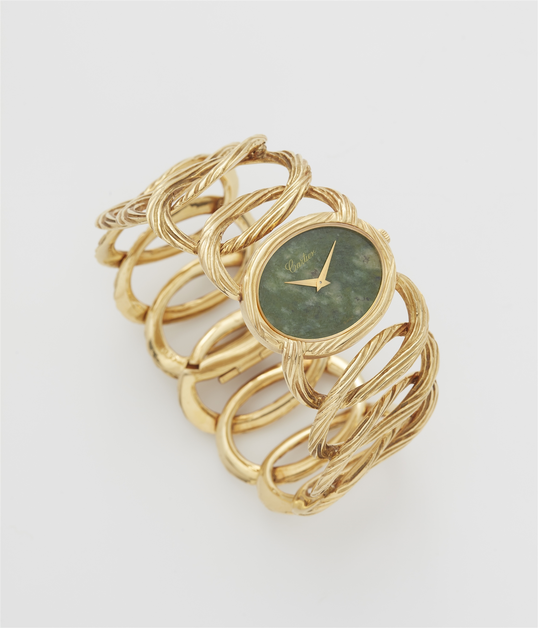 An 18k yellow gold and mottled green nephrite jade ladies' Piaget cuff wristwatch retailed by Cartie