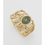 An 18k yellow gold and mottled green nephrite jade ladies' Piaget cuff wristwatch retailed by Cartie