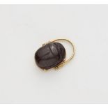 An Archäological Revival 18k gold and carved brown hardstone scarab swivel ring.