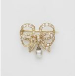 A 14k gold and European old-cut diamond bow brooch with pearl droplet.