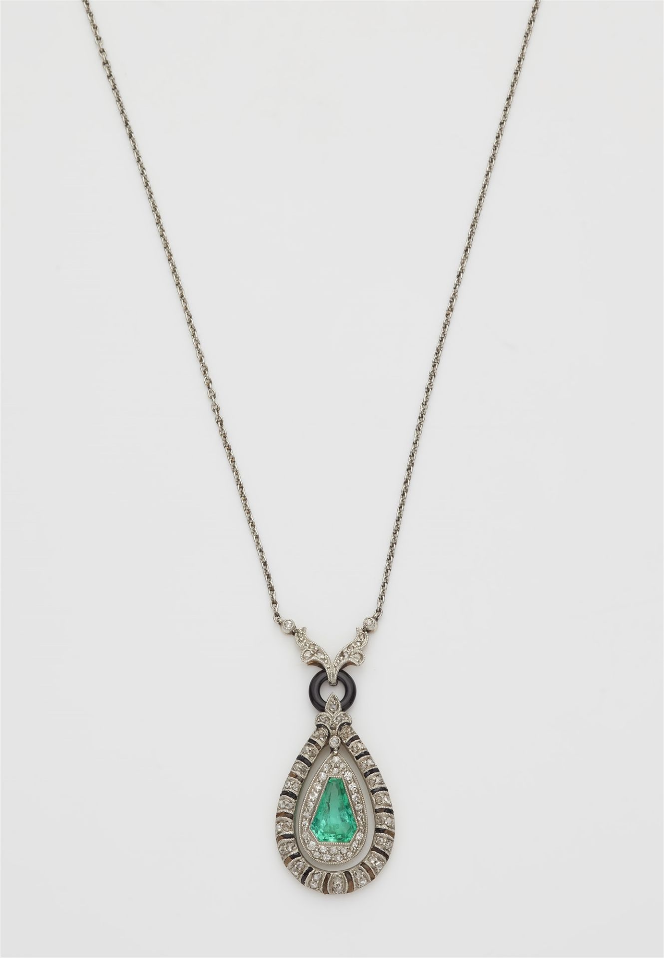 A platinum and 14k gold black enamel diamond onyx and emerald Art Déco pendant necklace.