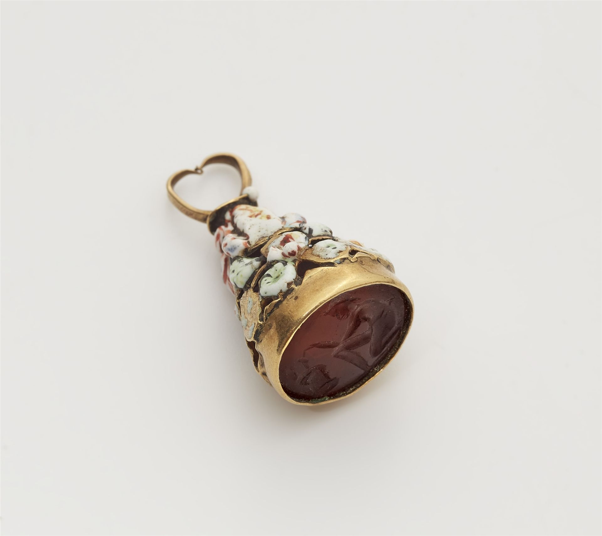 A possibly French gold and enamel breloque with an ancient Roman carnelian intaglio. Within it's ori