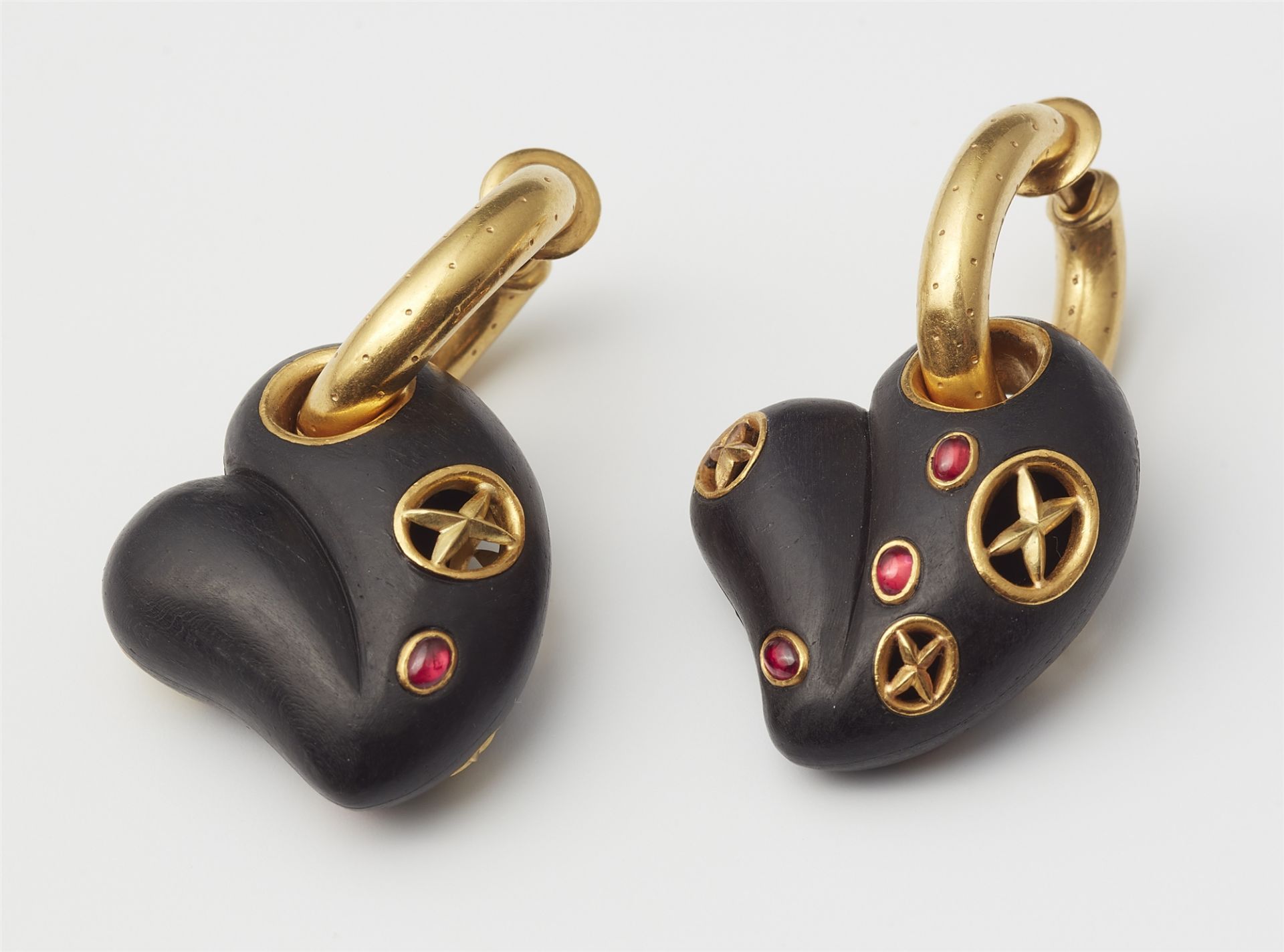 A pair of 18kt gold hoop earrings with ruby set carved ebony heart pendants. - Image 2 of 3