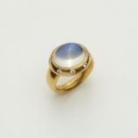 A hand forged 18k gold and diamond ring with large moonstone cabochon.