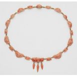 An Archaeological Revival style 18k gold and Sciacca coral cameo necklace.