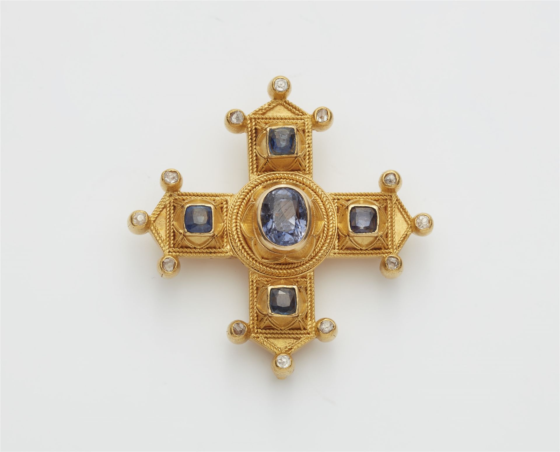An Italian Byzantine Revival 18k gold and sapphire cross pendant brooch.