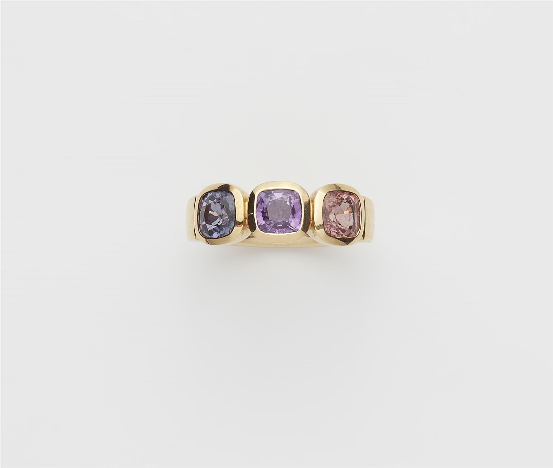 A German 18k gold and coloured sapphire three stone ring.