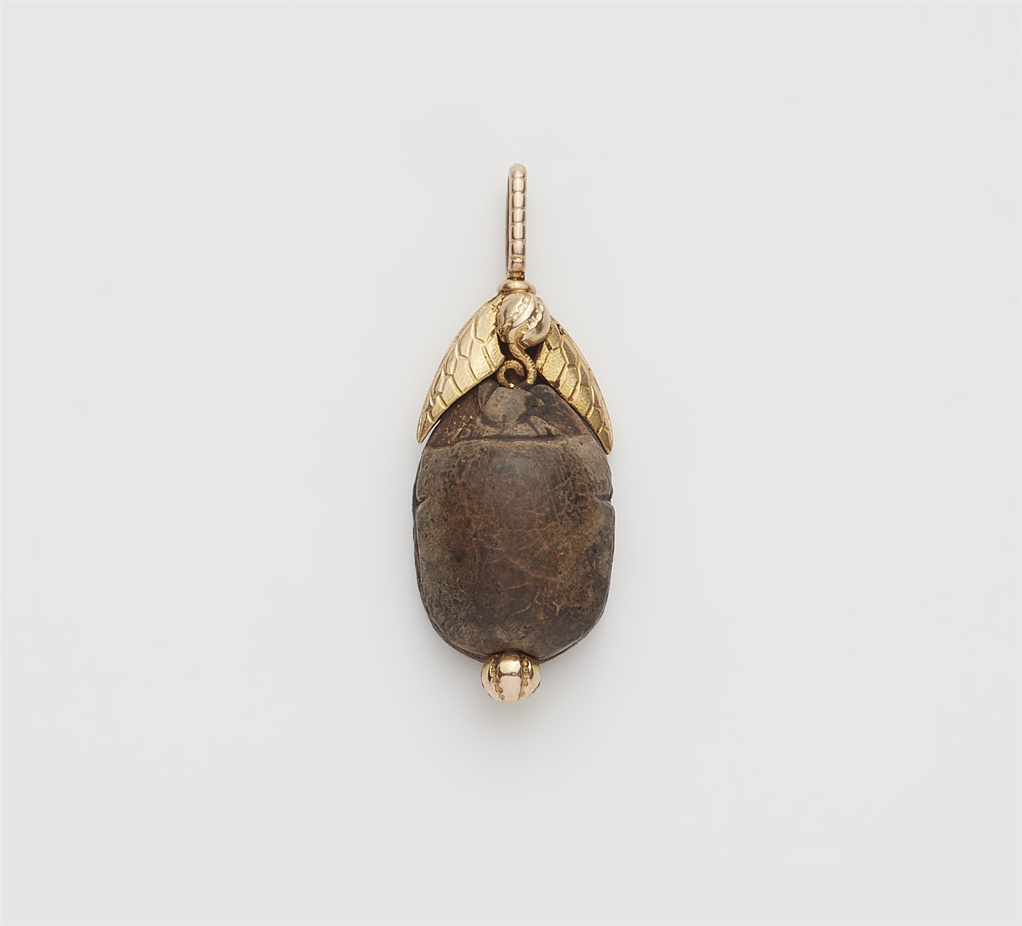 A Neoclassical 14k gold and Ancient Egyptian steatite scarab pendant.