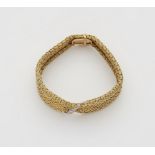 A flexible 18k gold meshwork bracelet with diamond strip.