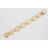 A German 14k rose gold bracelet with seven gold coins.