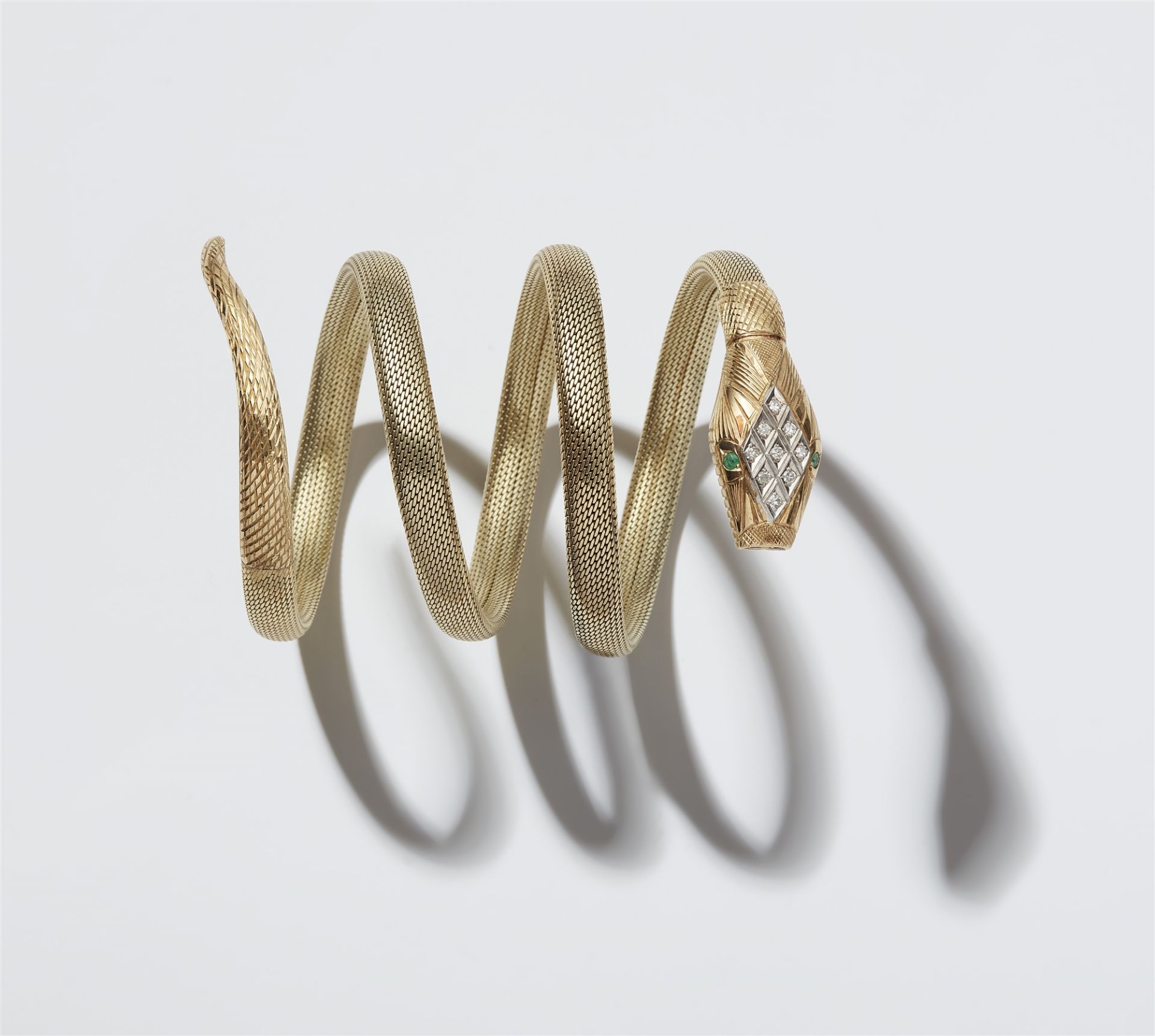 A flexible 14k gold tubogaz snake bracelet with jewelled head.