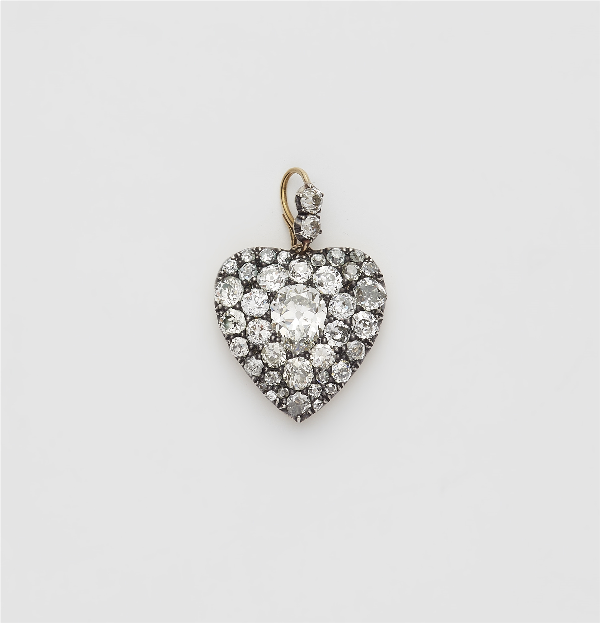 A Victorian silver 18k gold and diamond heart locket.