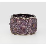 An oxidised silver gold and ruby cuff bracelet.