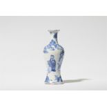 A small baluster-form faience vase with Chinoiserie decor