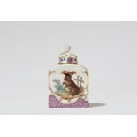 A Meissen porcelain tea caddy with a dog in a costume and poultry