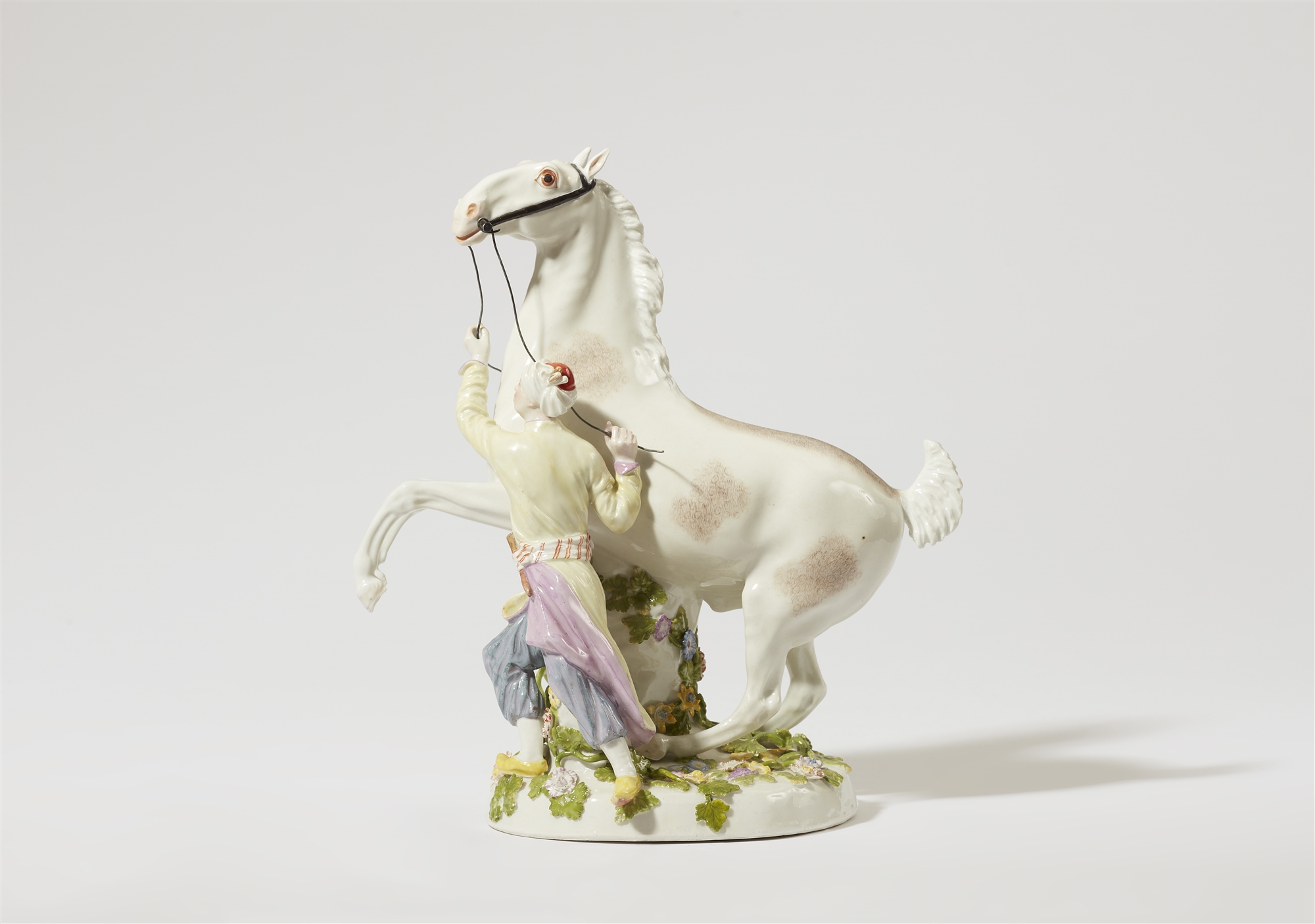 A Meissen porcelain model of a Turkish man taming a rearing horse