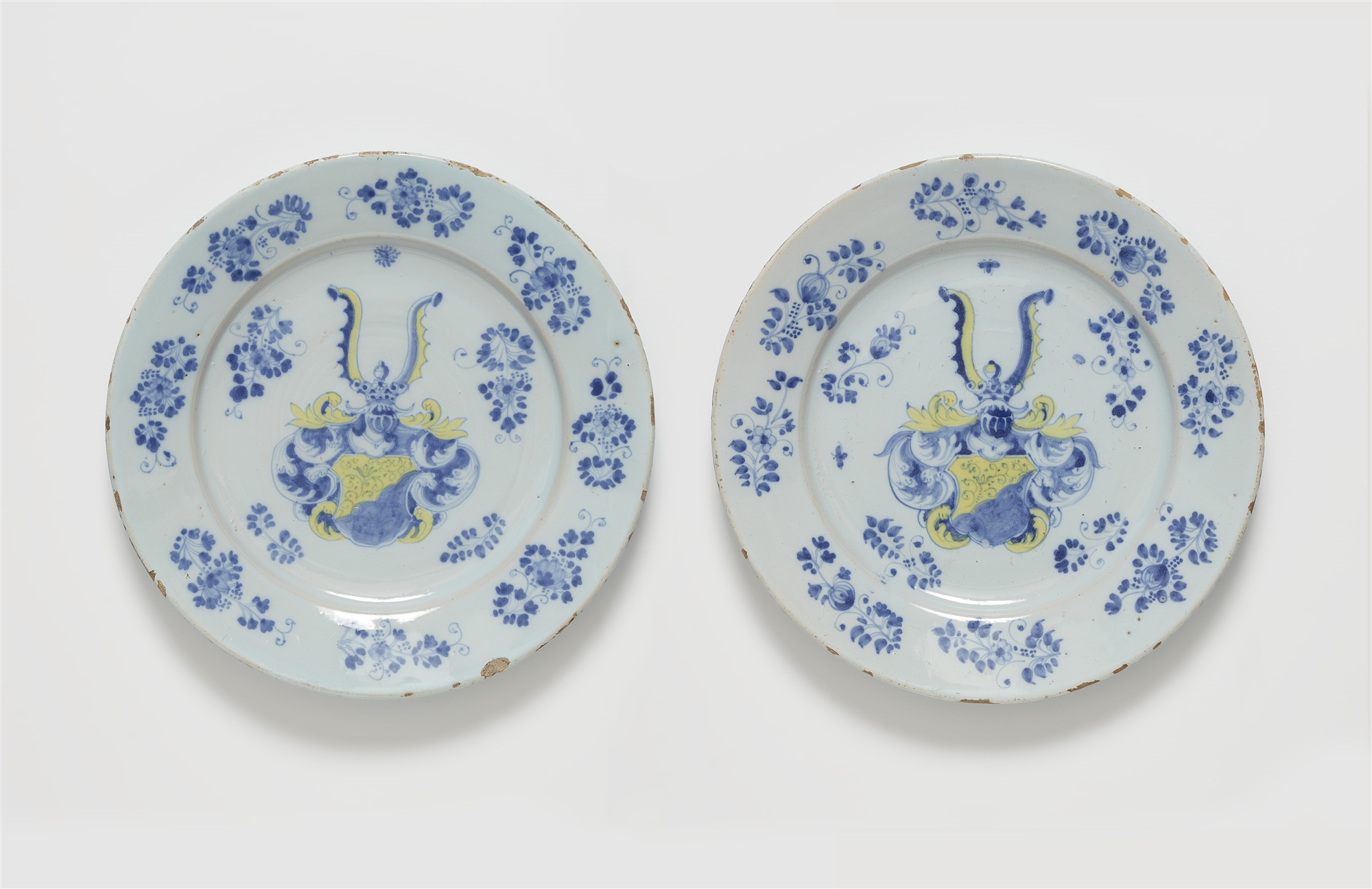 A pair of faience dishes from a heraldic service in two colours