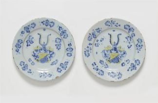 A pair of faience dishes from a heraldic service in two colours