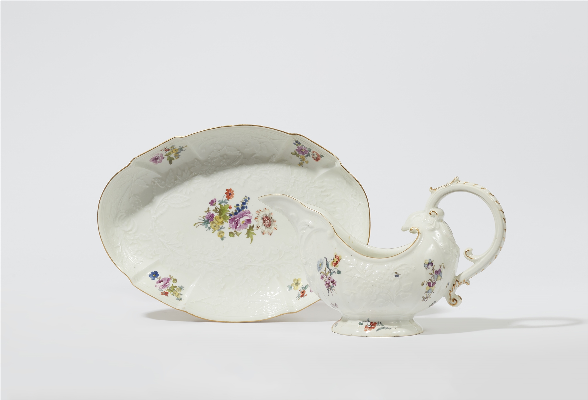 A Meissen porcelain sauce boat and dish from a dinner service with floral decor