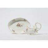 A Meissen porcelain sauce boat and dish from a dinner service with floral decor