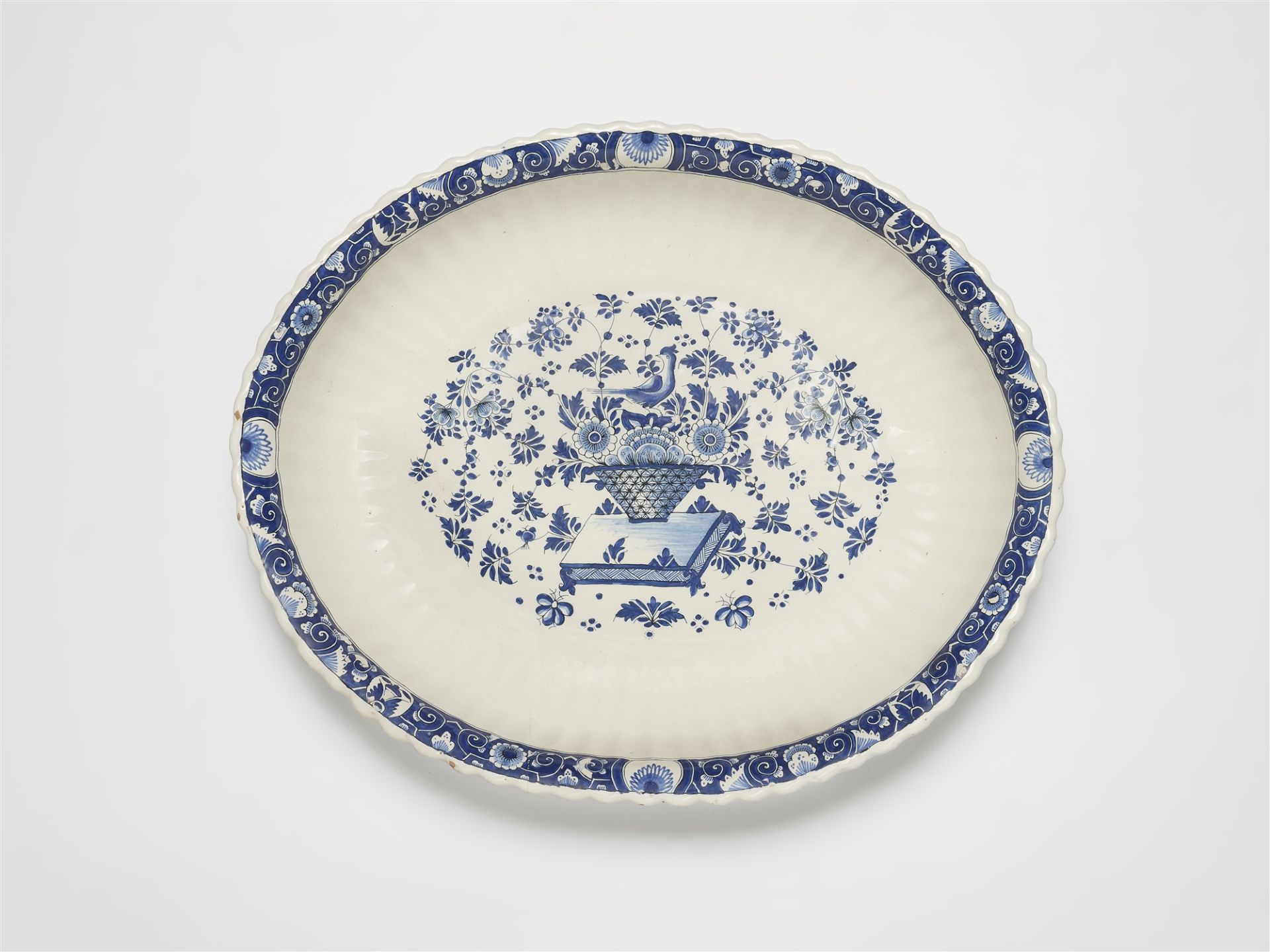 An oval Strasbourg faience dish with decor in the manner of Bérain