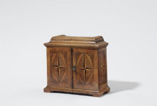 A small cabinet chest with star inlays