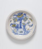A faience dish painted in blue and yellow