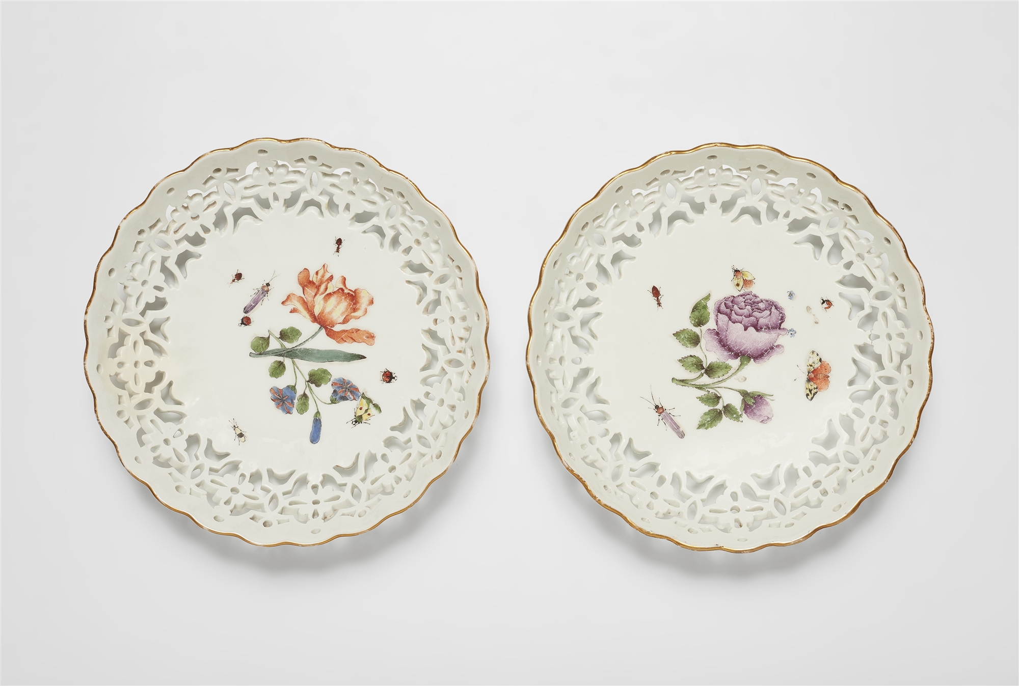 A pair of Meissen porcelain dessert baskets with woodcut style flowers and insects