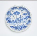 A faience dish with Chinoiserie motifs and an elephant