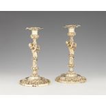 A pair of George II silver gilt candlesticks