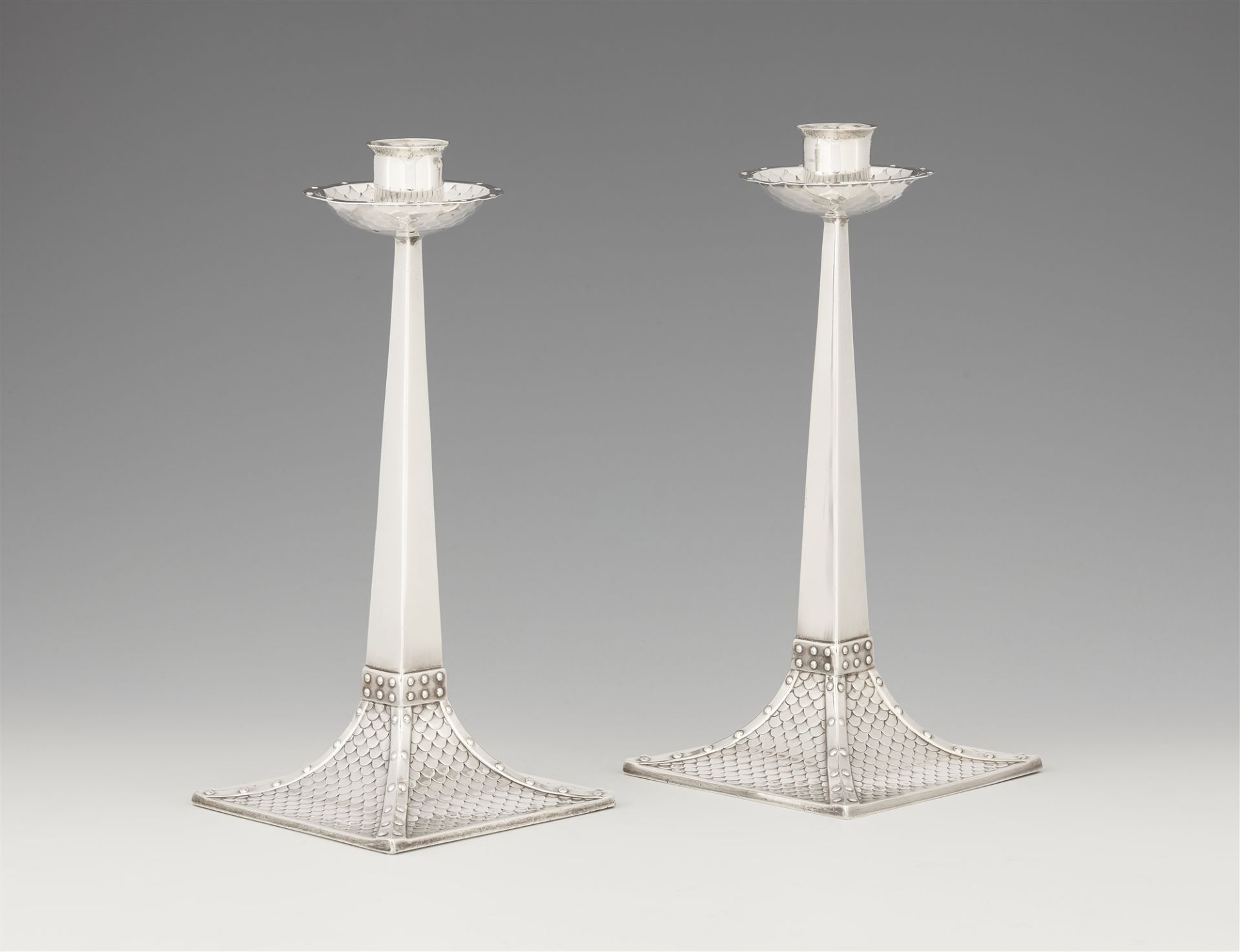 A pair of Arts and Crafts silver candlesticks