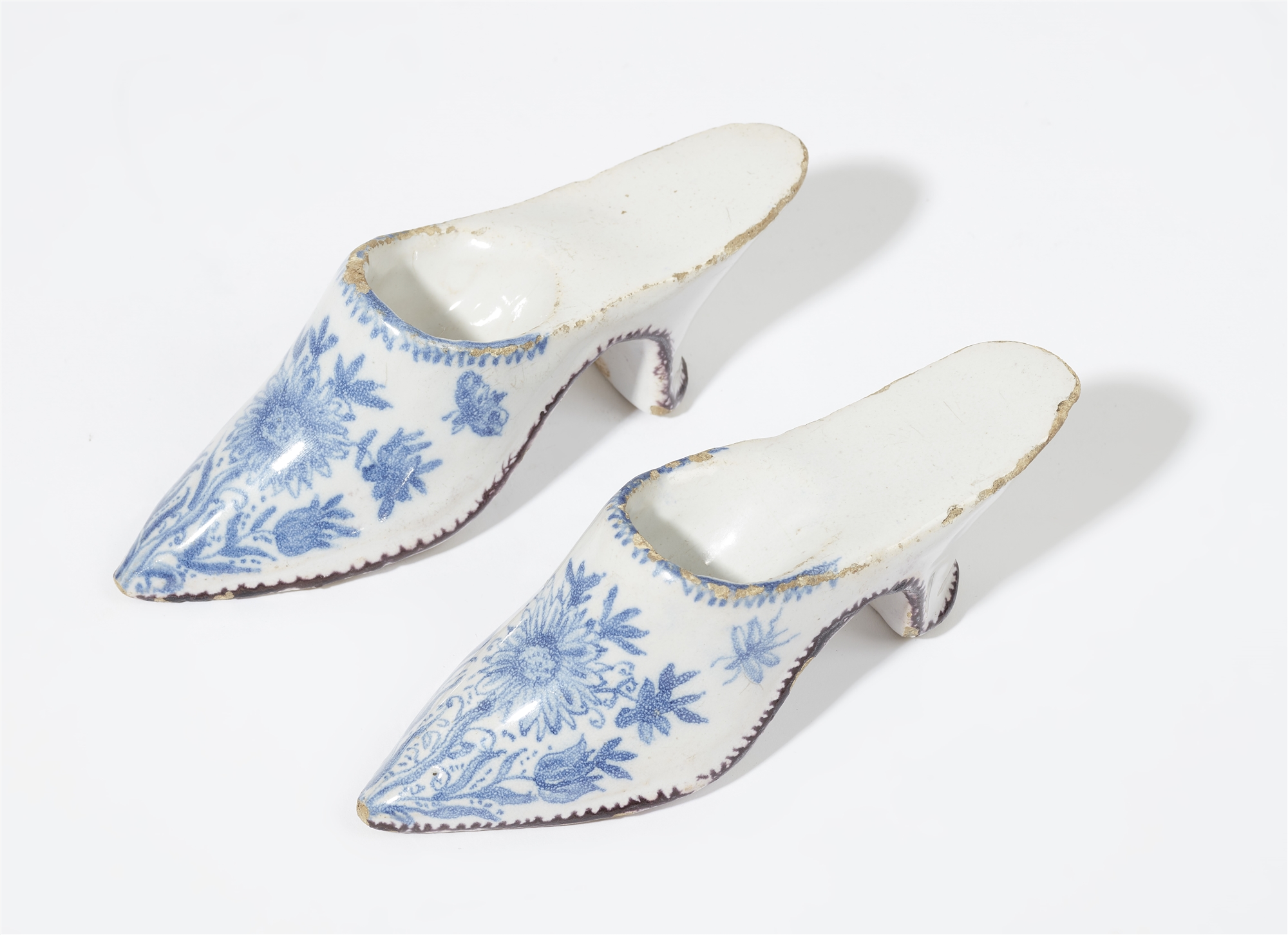 A small pair of faience slippers