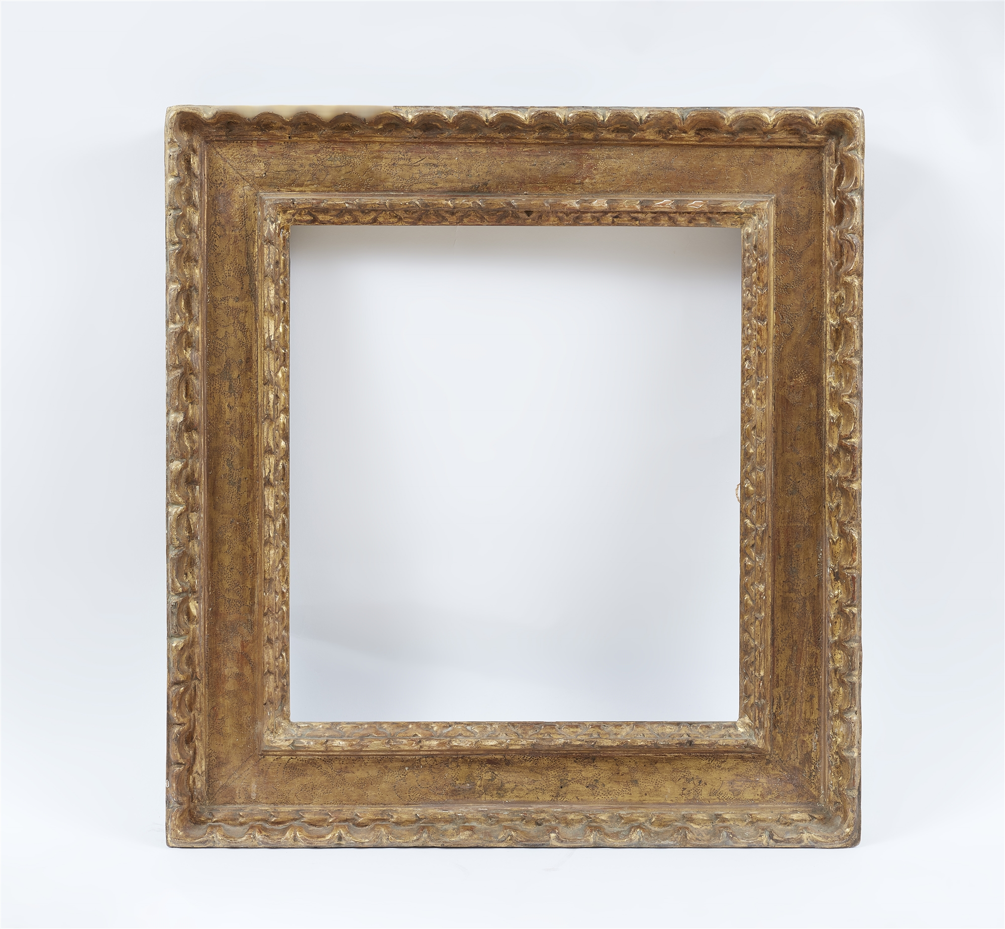 An Italian giltwood frame with graffito decor