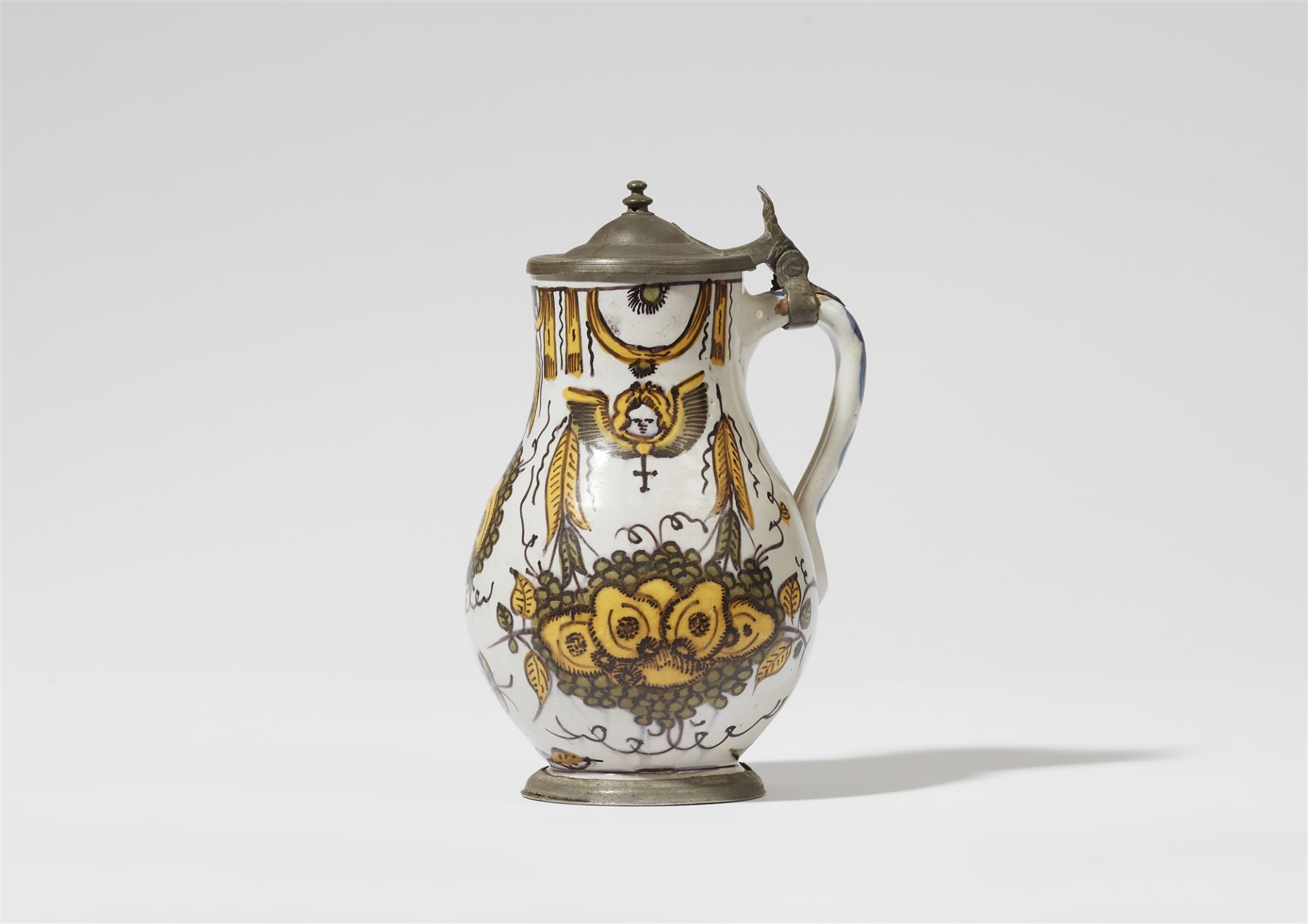 A faience jug with a fruit still life and angels